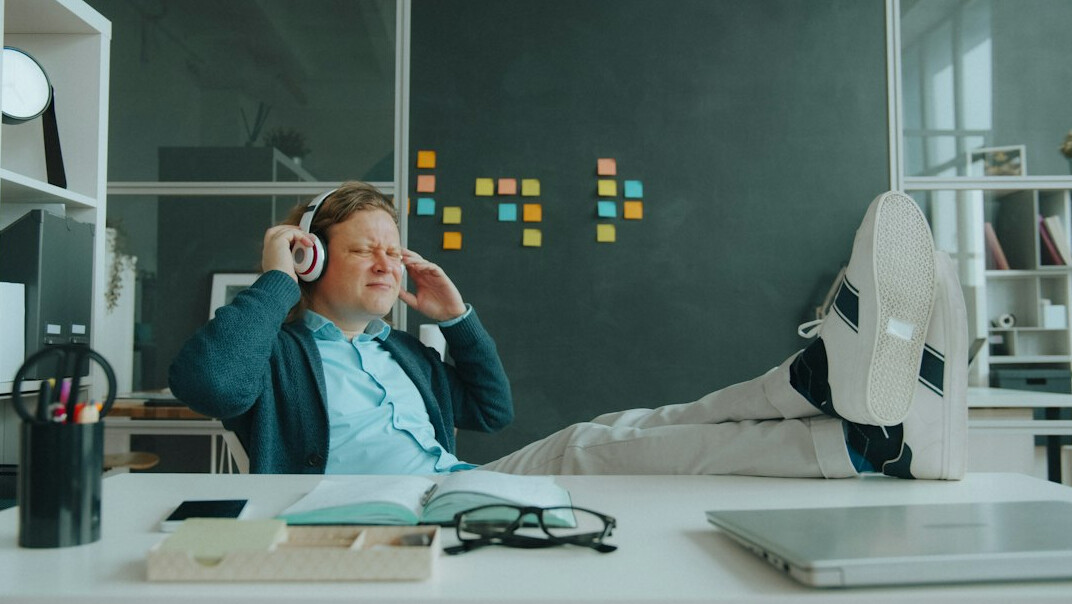 man reading book at desk